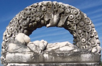 Sleeping child with rose arch and dove